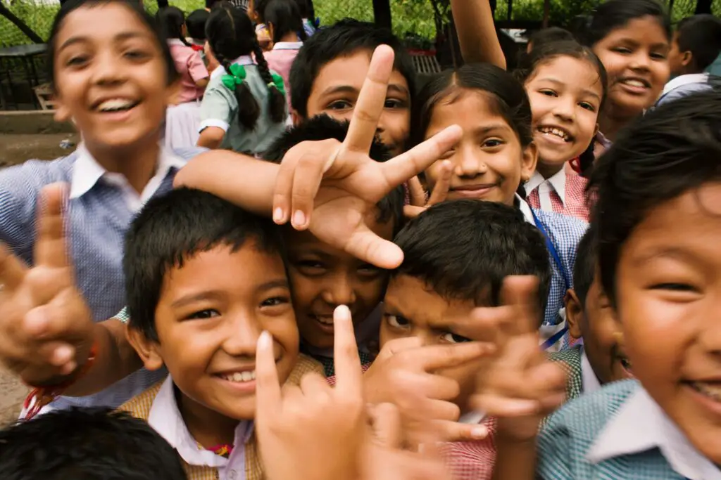 Several young children smiling at camera